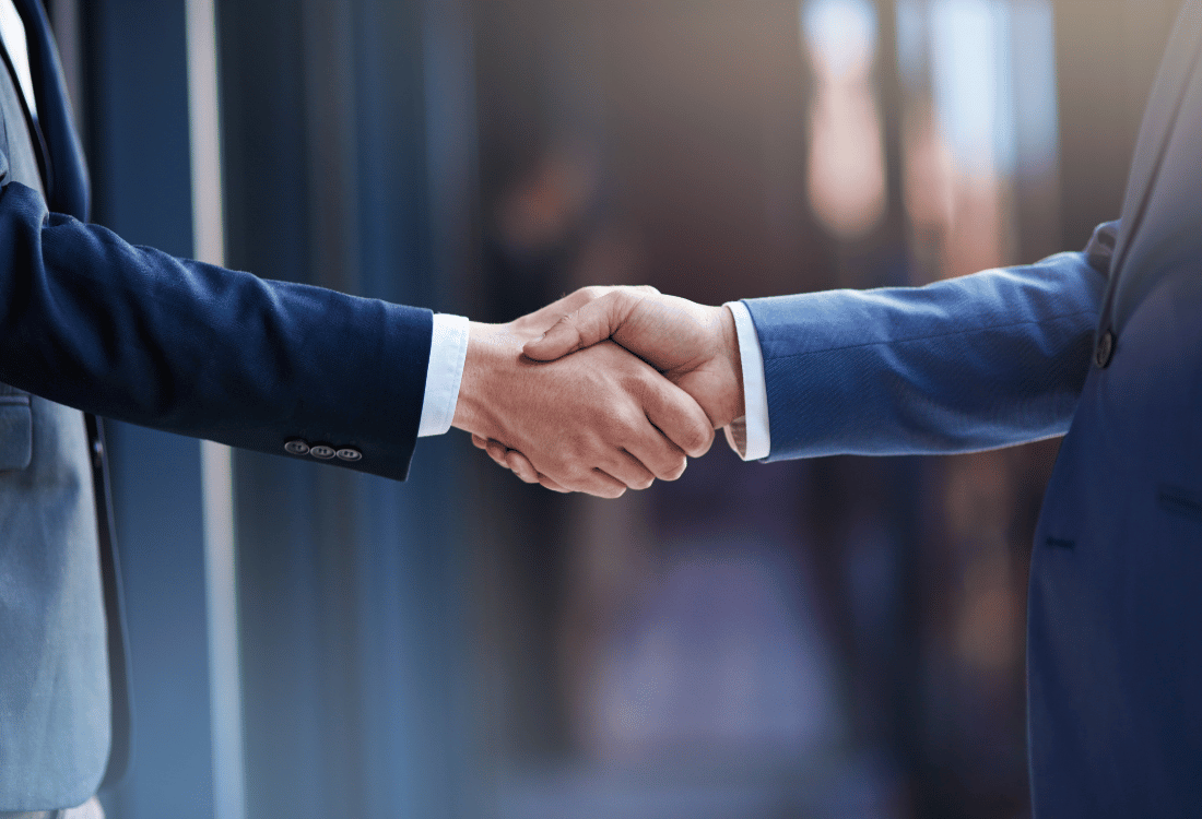 A firm handshake between an industry leader and a representative of Rainford Precision machines, highlighting their commitment to forging exclusive global collaborations that are essential to achieving unparalleled precision in engineering.